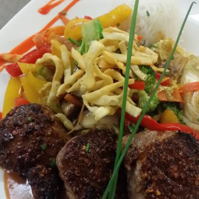 Thai spiced Porktenderloin Medallions over Thai Curry sauce, Wok vegetables & fruit Chutney