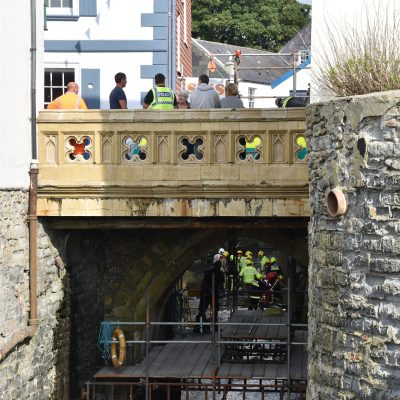 The Worker fell off the scaffolding working on the bridge.
